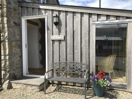 An outdoor area with a bench and flower pot at Y Cwtch Newport