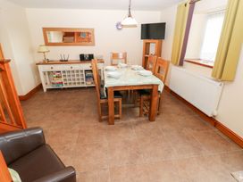 A dining room with table and chairs at Bwthyn Trecoed St. Clears near Carmarthen