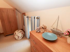 A bedroom with a wardrobe and teddy bears at Bwthyn Trecoed St. Clears near Carmarthen