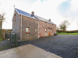 A house with stone walls and a gate at Bwthyn Trecoed St. Clears near Carmarthen