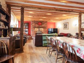 A dining room with a table and chairs at Ysgubor Pwlliago, Pennant Valley near Llangynog