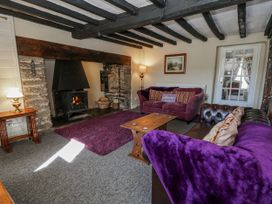 A living room with a fireplace and sofas at Penlone Cottage Rhayader