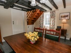 A dining room with a table and chairs at Penlone Cottage in Rhayader