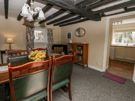 A dining room with a table and chairs at Penlone Cottage Rhayader