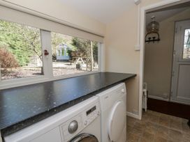 A utility room with a washing machine and counter at Penlone Cottage Rhayader