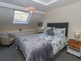 A bedroom with a bed and window at Penlone Cottage in Rhayader