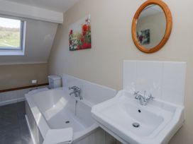 A bathroom with a bathtub and sink at Penlone Cottage Rhayader