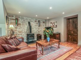 A living room with a sofa and a coffee table at The Lodge Farm Barn Deepdean near Ross-on-Wye