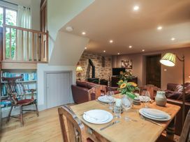 A dining room with a table set for dinner at The Lodge Farm Barn Deepdean near Ross-on-Wye