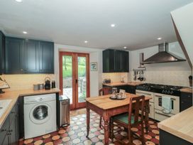 A kitchen with a table and chairs at The Lodge Farm Barn in Deepdean near Ross-on-Wye