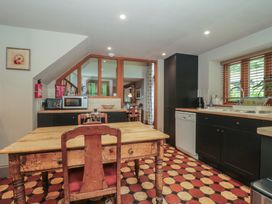 A kitchen with a table and chairs at The Lodge Farm Barn Deepdean near Ross-on-Wye