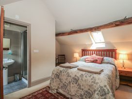A bedroom with a bed and ensuite bathroom at The Lodge Farm Barn Deepdean near Ross-on-Wye