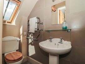 A bathroom with a sink, toilet, and towel rail at The Lodge Farm Barn in Deepdean near Ross-on-Wye