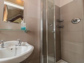 A bathroom with a sink and shower at The Lodge Farm Barn in Deepdean near Ross-on-Wye