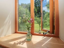A window with a flower vase on the sill at The Lodge Farm Barn in Deepdean near Ross-on-Wye
