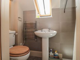 A bathroom with a toilet and wash basin at The Lodge Farm Barn Deepdean near Ross-on-Wye