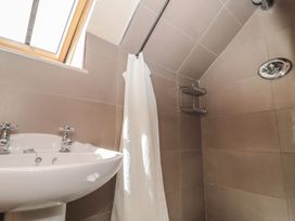 A bathroom with a basin and shower at The Lodge Farm Barn in Deepdean near Ross-on-Wye