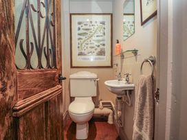 A bathroom with a toilet and sink at The Lodge Farm Barn in Deepdean near Ross-on-Wye