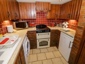 A kitchen with appliances and cabinets at Severn Bank Lodge Astley Burf near Stourport-on-Severn