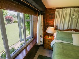 A bedroom with a bed and window at Severn Bank Lodge in Astley Burf near Stourport-on-Severn
