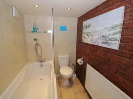 A bathroom with a bathtub and toilet at Severn Bank Lodge in Astley Burf near Stourport-on-Severn
