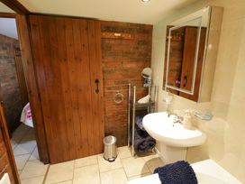 A bathroom with a sink and mirror at Severn Bank Lodge in Astley Burf near Stourport-on-Severn