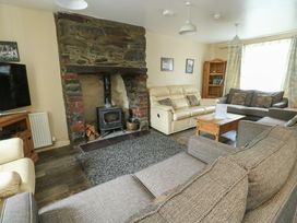 A living room with a fireplace and sofas at Halford Hill Llanberis