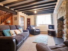 A living room with sofas and a TV at Bryn Re Trawsfynydd near Llan Ffestiniog and Dolgellau