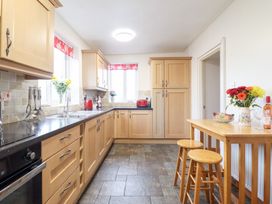 A kitchen with cabinets and a table at Bryn Re Trawsfynydd near Llan Ffestiniog and Dolgellau