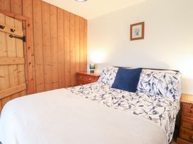 A bedroom with a bed, bedside table and lamp at Bryn Re Trawsfynydd near Llan Ffestiniog and Dolgellau