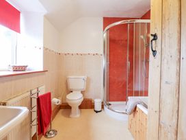 A bathroom with a shower and bathtub at Bryn Re in Trawsfynydd near Llan Ffestiniog and Dolgellau