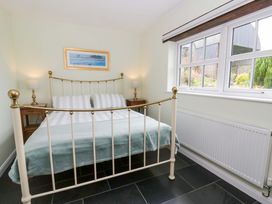 A bedroom with a bed and nightstands at Blaenffynnon Bach in Trelech near Crymych