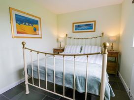 A bedroom with a bed and bedside tables at Blaenffynnon Bach in Trelech near Crymych
