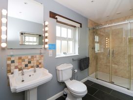 A bathroom with a sink and shower enclosure at Blaenffynnon Bach in Trelech near Crymych