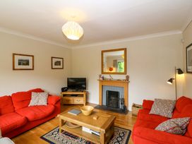 A living room with a sofa and television at Rowantree in Beaufort, County Kerry
