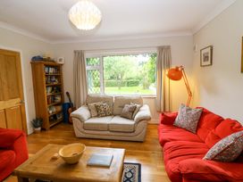 A living room with a sofa, armchair, and a coffee table at Rowantree, Beaufort, County Kerry