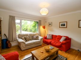 A living room with a sofa and guitar at Rowantree in Beaufort, County Kerry