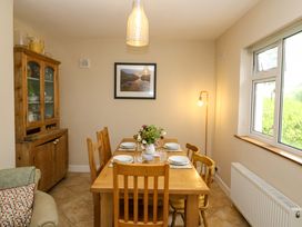 A dining room with a table and chairs at Rowantree, Beaufort, County Kerry