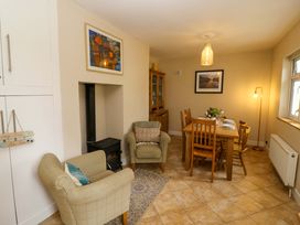 A dining room with a table and chairs at Rowantree, Beaufort, County Kerry