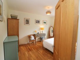 A bedroom with a bed and desk at Rowantree in Beaufort, County Kerry