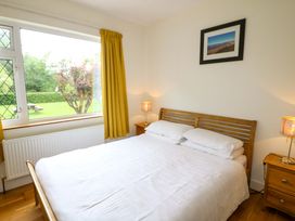 A bedroom with a bed and a window at Rowantree in Beaufort, County Kerry