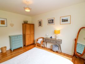 A bedroom with a bed and furniture at Rowantree, Beaufort, County Kerry