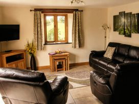 A living room with a sofa and television at Tyn Y Celyn Canol Clocaenog near Ruthin