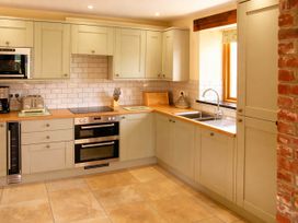A kitchen with cabinets and appliances at Tyn Y Celyn Canol near Clocaenog
