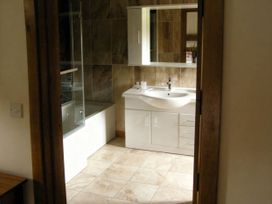 A bathroom with a shower and bathtub at Tyn Y Celyn Canol in Clocaenog near Ruthin