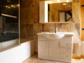 A bathroom with a bathtub and sink at Tyn Y Celyn Canol Clocaenog near Ruthin