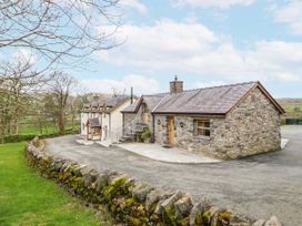 A house with a stone exterior and a driveway at Briws and 963354 together they sleep 35