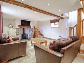 A living room with a fireplace and television at Briws and 963354 together they sleep 35