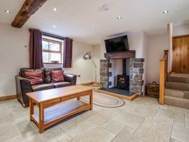 A living room with a sofa and coffee table at Briws and 963354 together they sleep 35