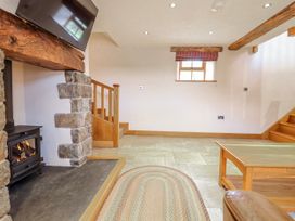 A living room with a fireplace and staircase at Briws and 963354 together they sleep 35